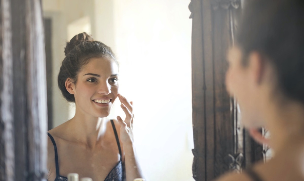 Woman looking in mirror. Image: Pexels - Andrea Piacquadio
