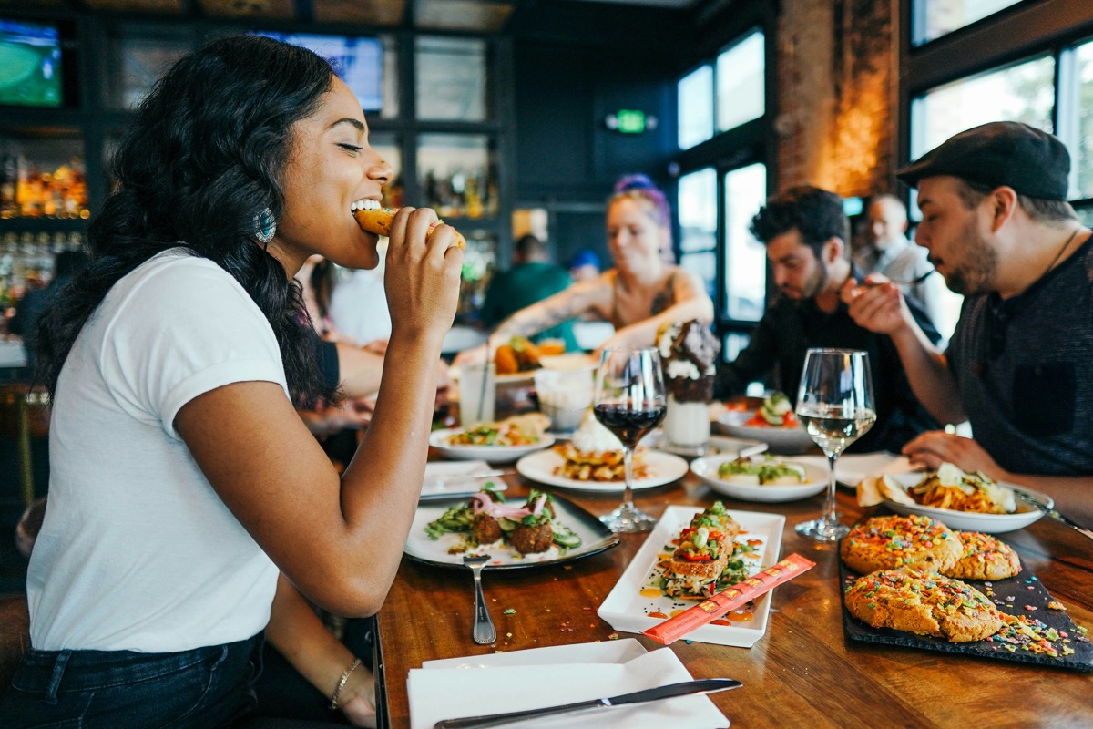 Girl eating a cookie at the dinner table