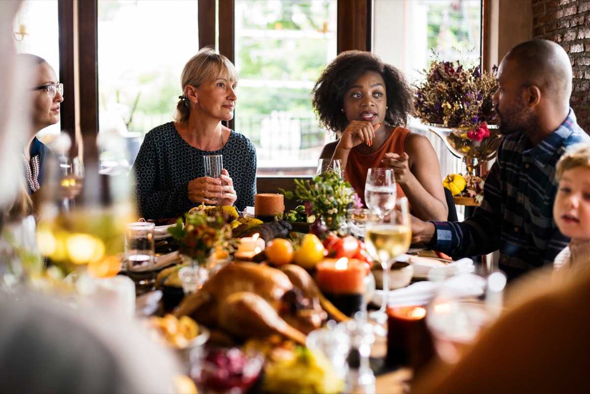 People eating around a holiday table