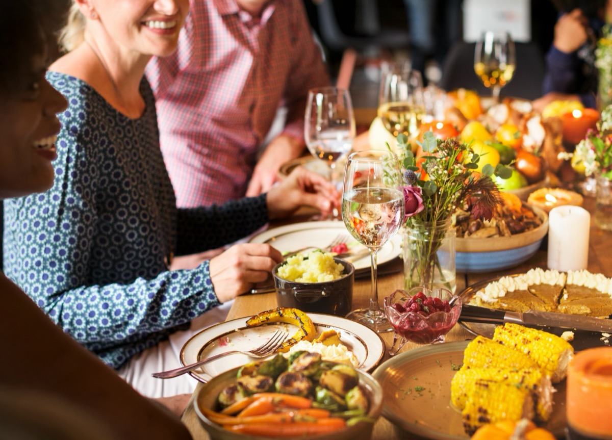 People eating around holiday table