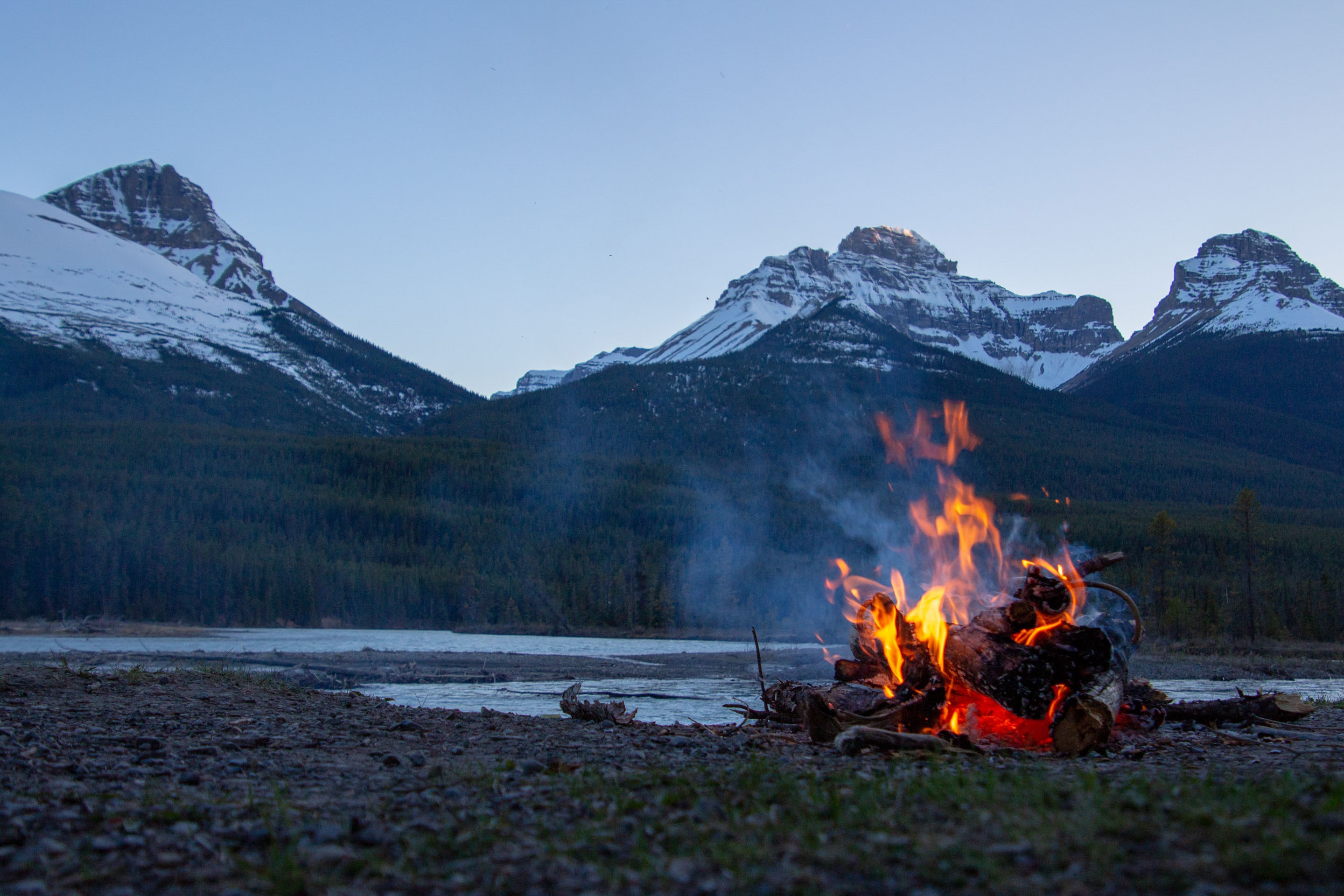 Summer time fire-it in front of mountains. Unsplash - Courtnie Tosana