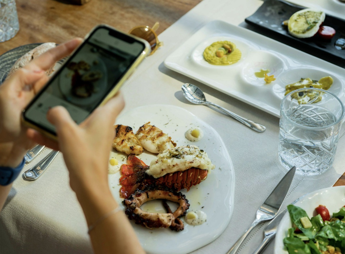 Taking a picture of food. Image: Pexels - Kadir Avşar