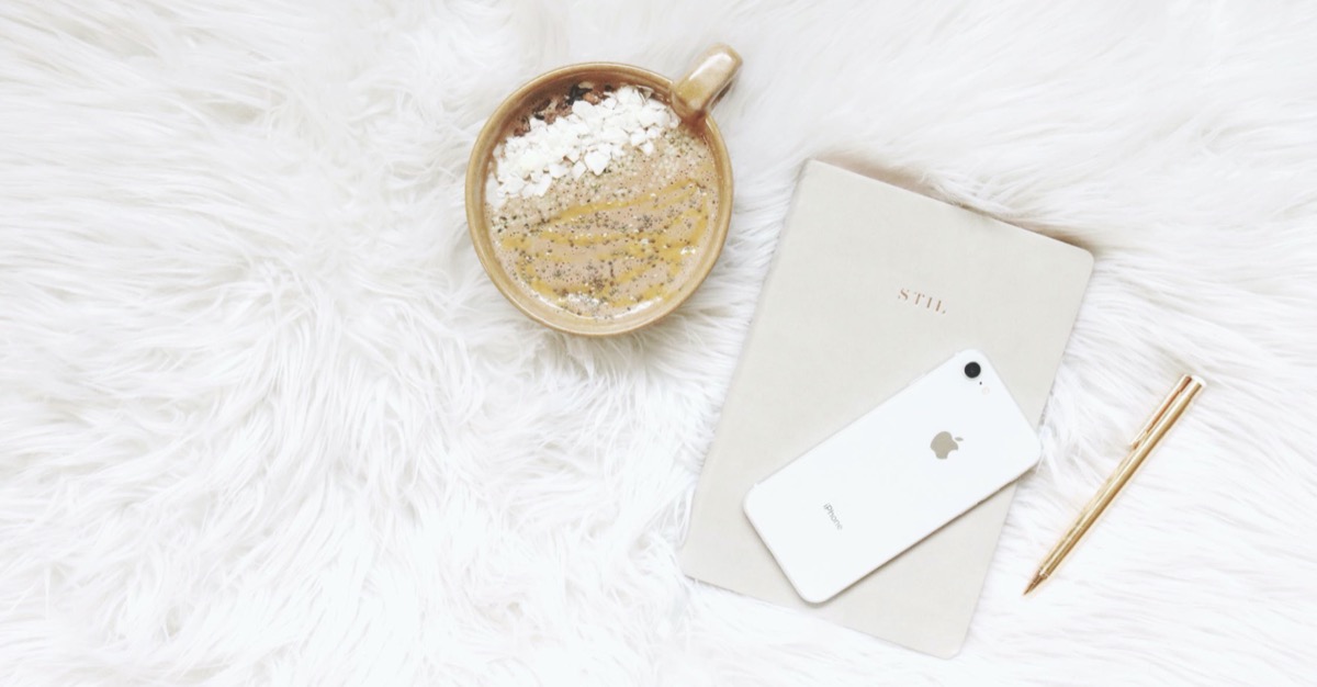 A bowl of oatmeal with phone and journal. Pexels - Madison Inouye