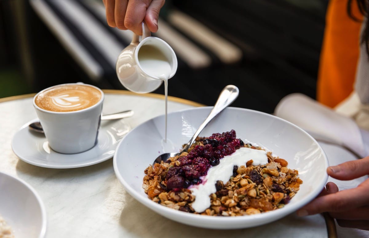 Eating a bowl of cereal and yogurt. Image: Pexels - Maria Bortolotto