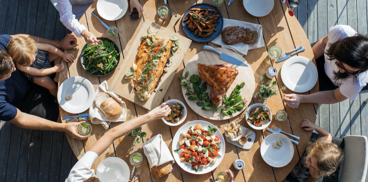 Social gathering, sharing a meal together. Unsplash - Luisa Brimble