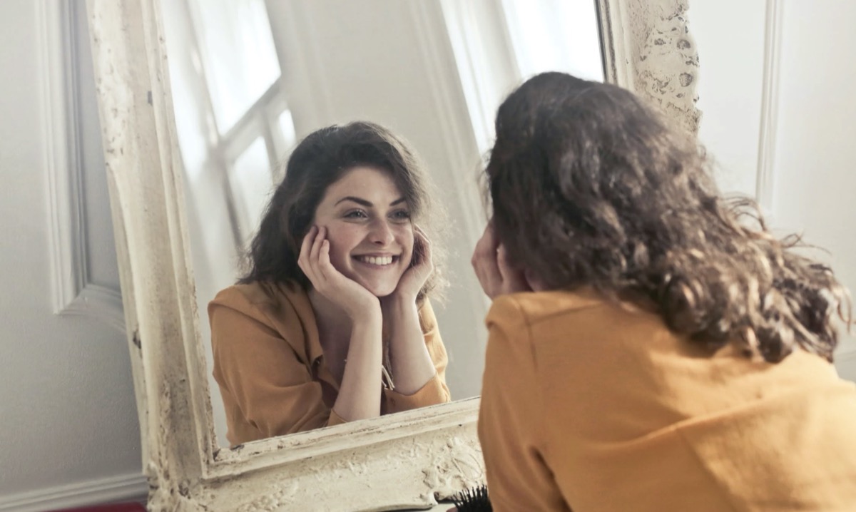 Woman looking in the mirror. Image: Pexels - Andrea Piacquadio